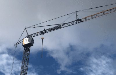 An operator training on a self-erecting tower crane during a Bigfoot Academy certification course.