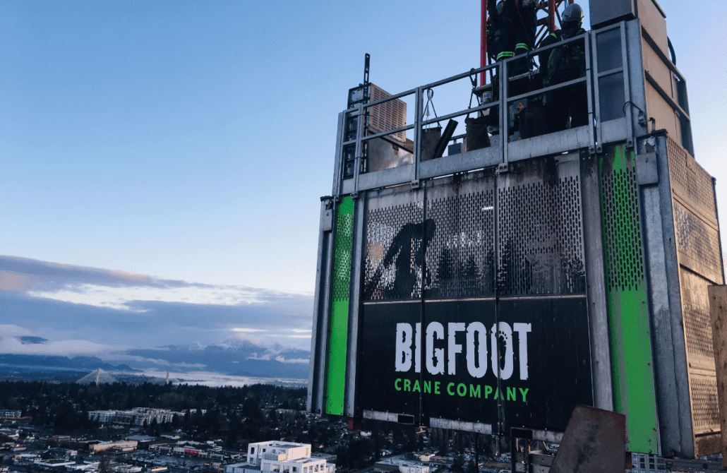 An operator at the controls of a construction personnel hoist, demonstrating skills learned in the Bigfoot Academy training course. 