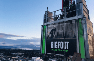An operator at the controls of a construction personnel hoist, demonstrating skills learned in the Bigfoot Academy training course. 