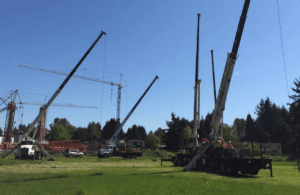 An operator practicing a lift with a truck-mounted stiff boom crane during a Bigfoot Academy certification course. 