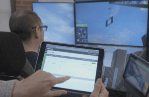 Professional conducting a post-injury assessment for a heavy equipment operator using an advanced simulator at Bigfoot Academy. 