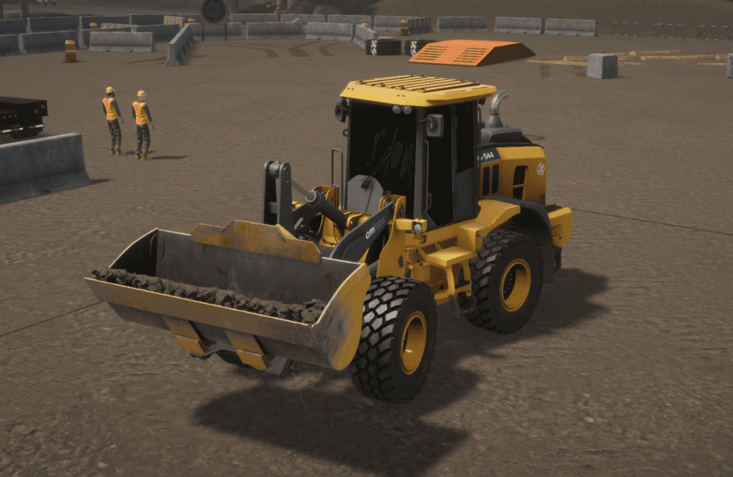A trainee operates a realistic wheel loader simulator with pedals and joysticks at the Bigfoot Academy training center. 