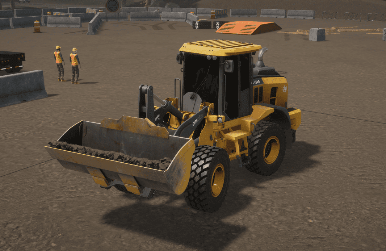 A trainee operates a realistic wheel loader simulator with pedals and joysticks at the Bigfoot Academy training center. 