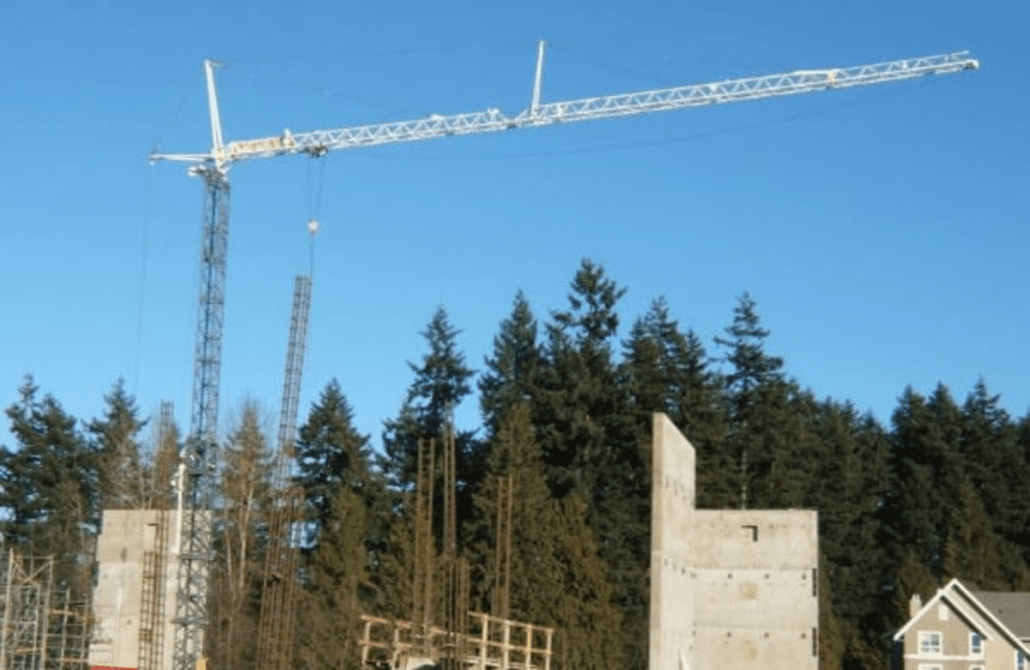 Used 2005 Comansa LC 5211 luffing jib crane, shown at a work site.