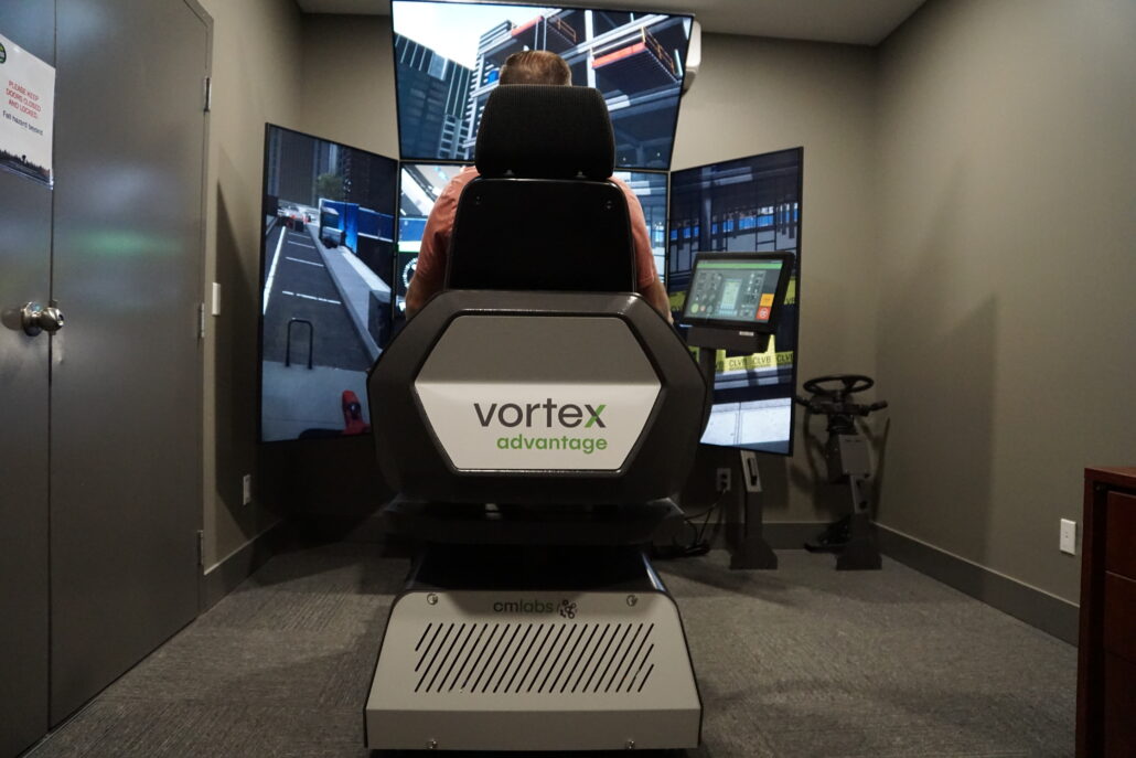 Trainee practicing crane operation on an advanced simulator for certification