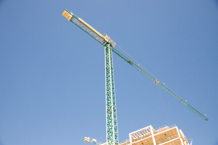 Green construction tower crane.