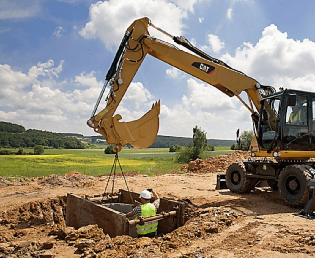 Construction crew using correct civil rigging terminology while positioning chain slings, shackles, and lifting hardware during a crane lift, reinforcing safe communication and proper equipment selection on site.