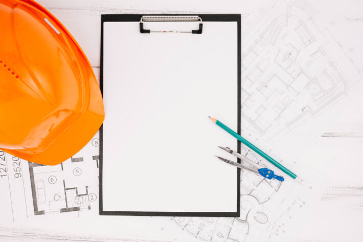 Construction helmet and architectural plans.