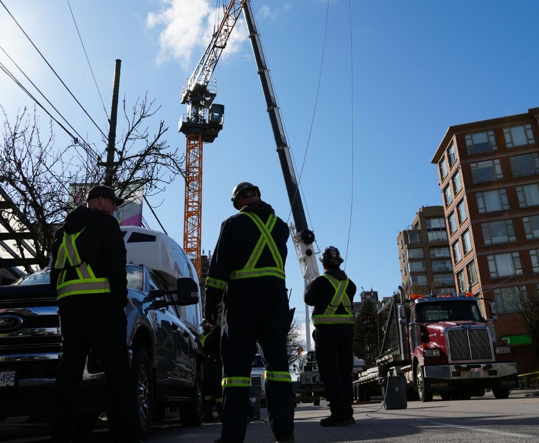 Construction crew standing idle on a jobsite waiting for work clearance or documentation approval