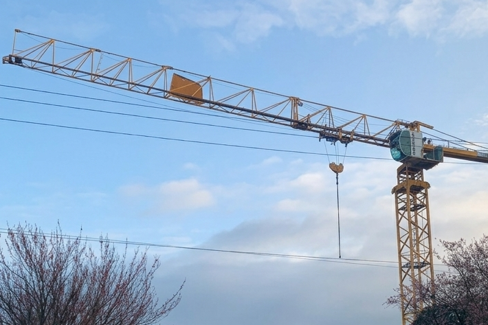 Large yellow construction tower crane.